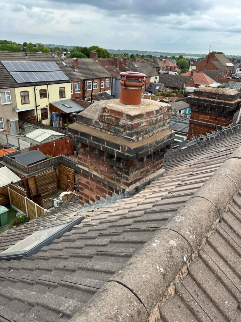 This is a photo taken from a roof which is being repaired by Crawley Roofing Repairs, it shows a street of houses, and their roofs