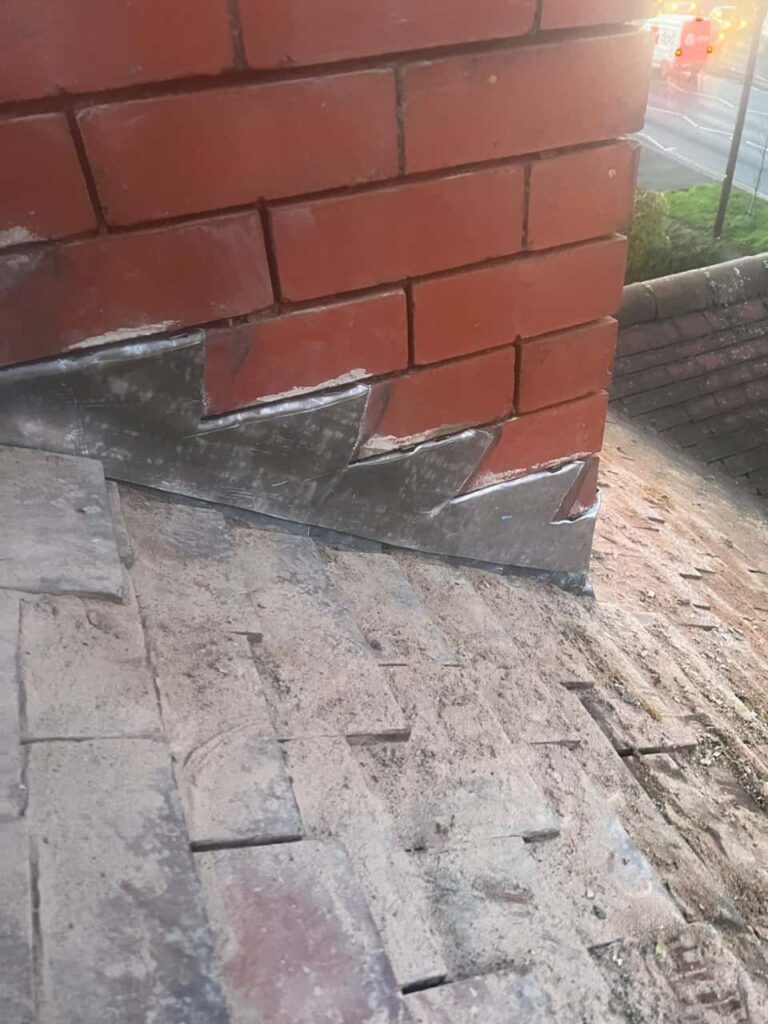 This is a photo of new leadwork being installed around an old chimney. Works carried out by Crawley Roofing Repairs